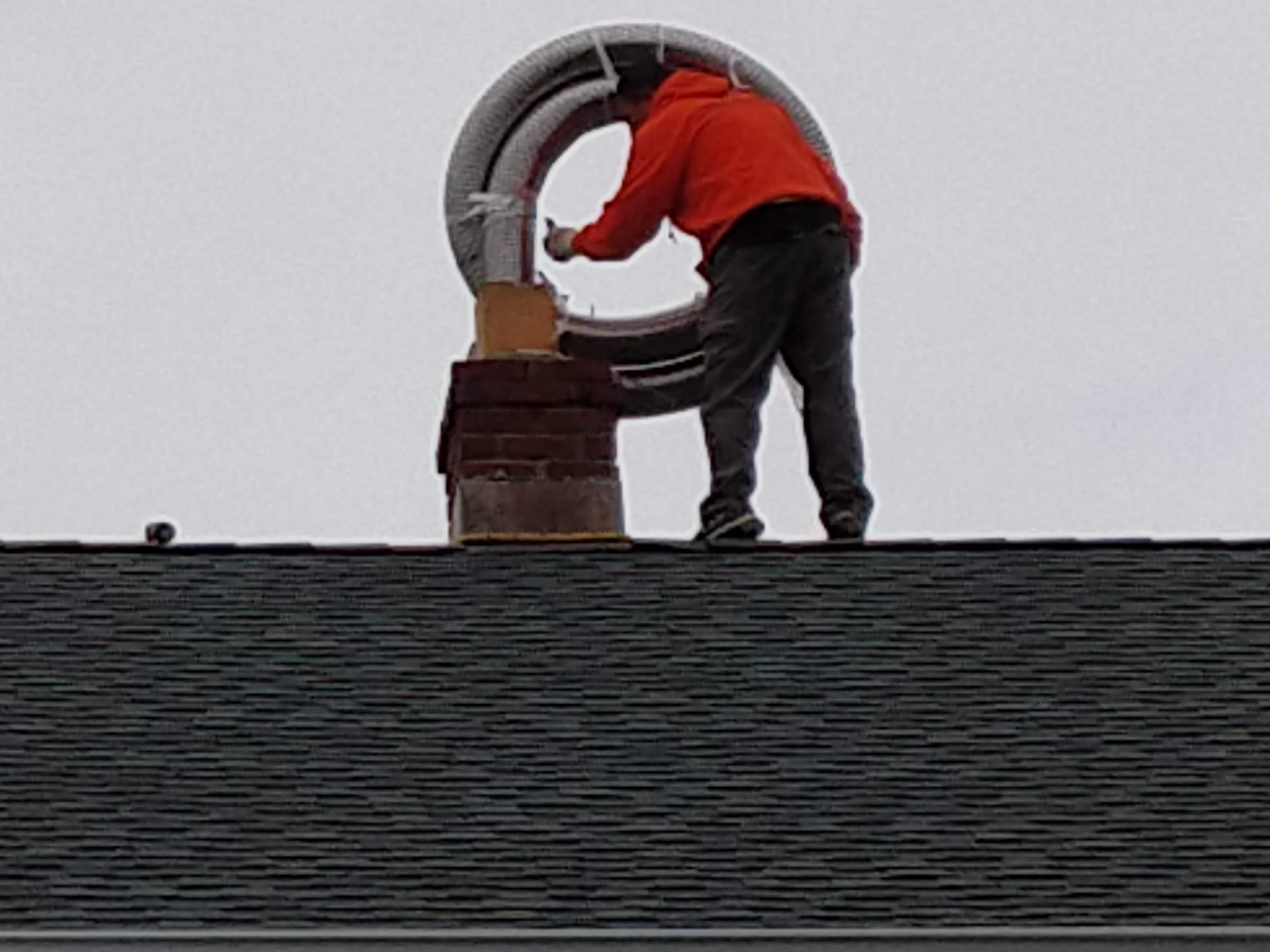Flexible stainless chimney liner being installed in Syosset, New York